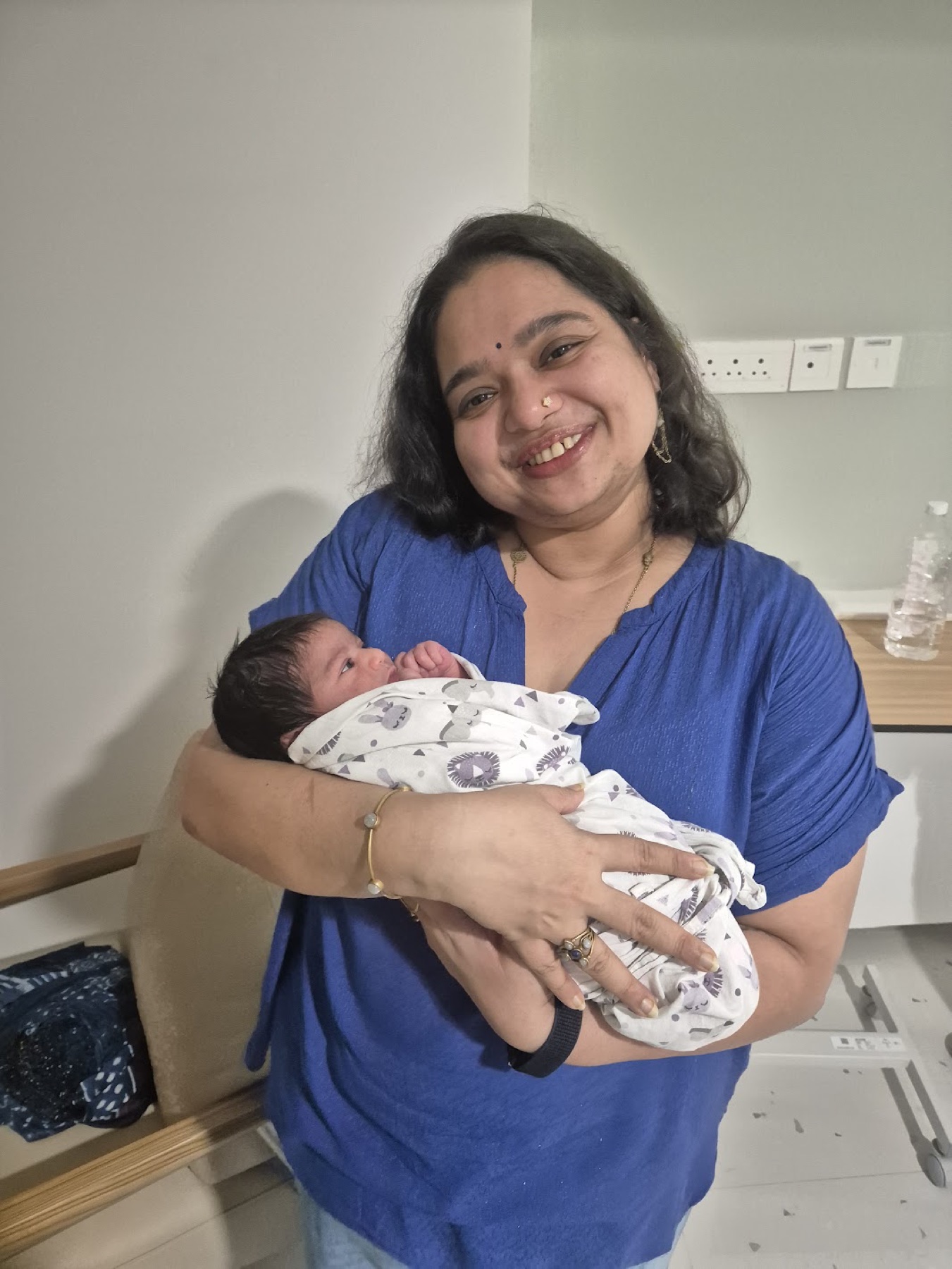 Adira being held by her Doddamma, her mother's elder sister.